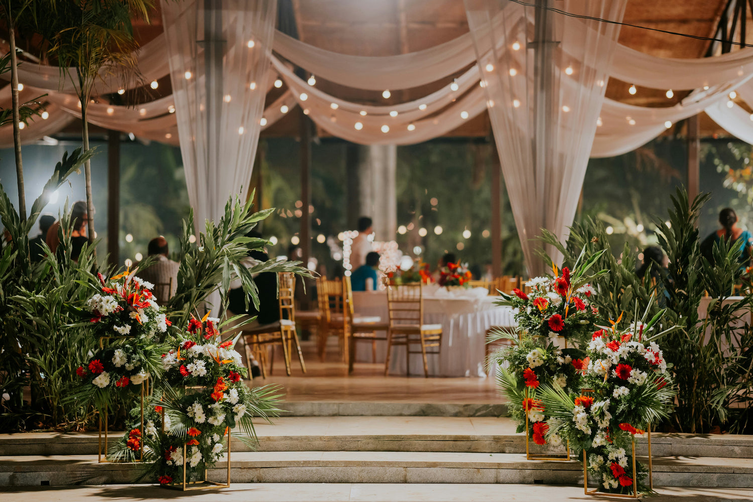 Floral hanging garland with roses and greenery on wedding arch
